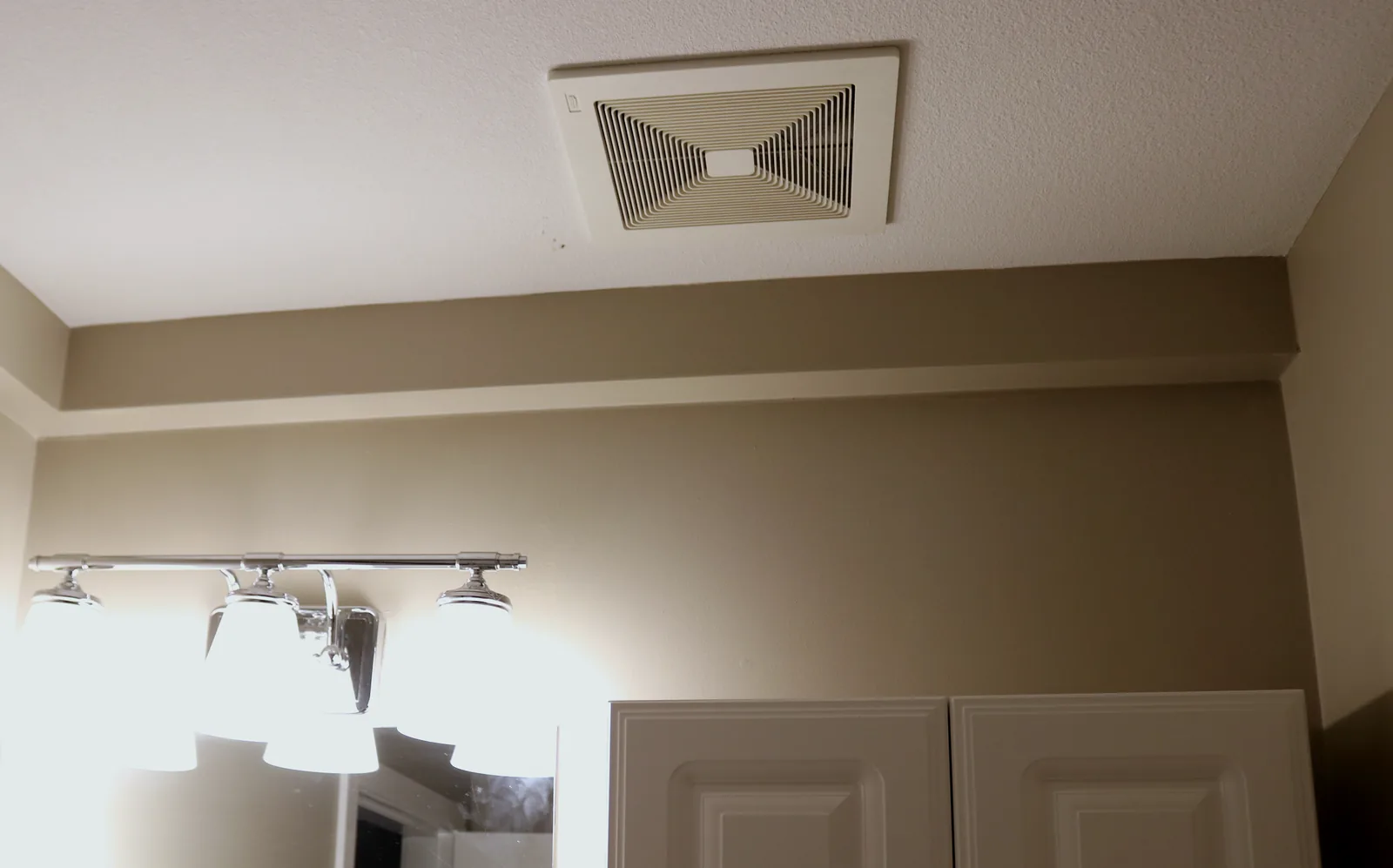 Plumbing Track enclosure in a bathroom below a ceiling vent